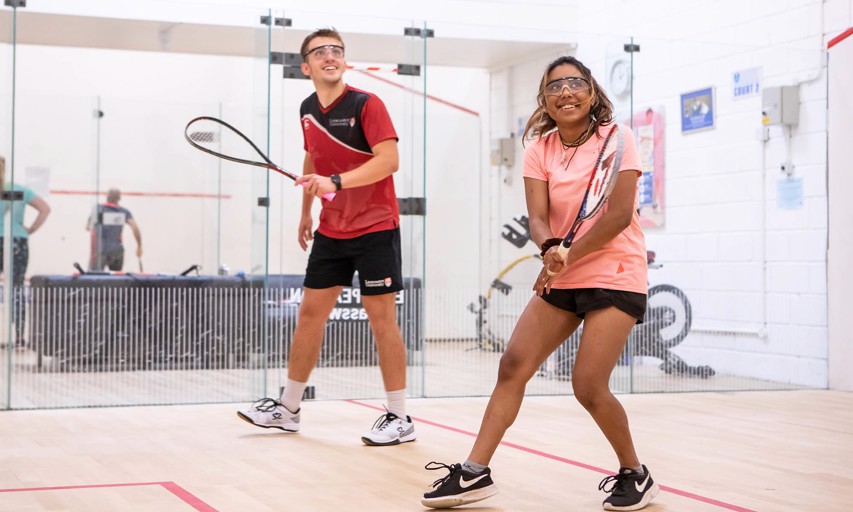 People playing squash on court